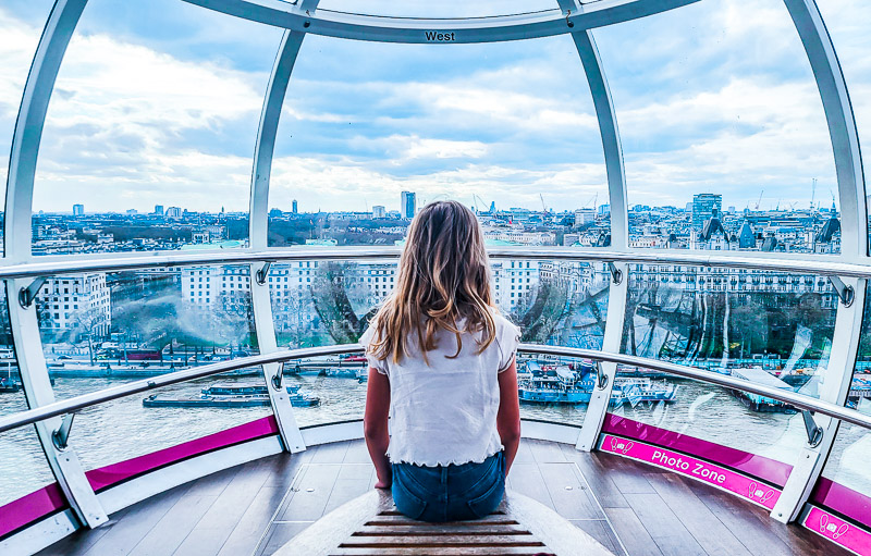 girl sitting on the river thames