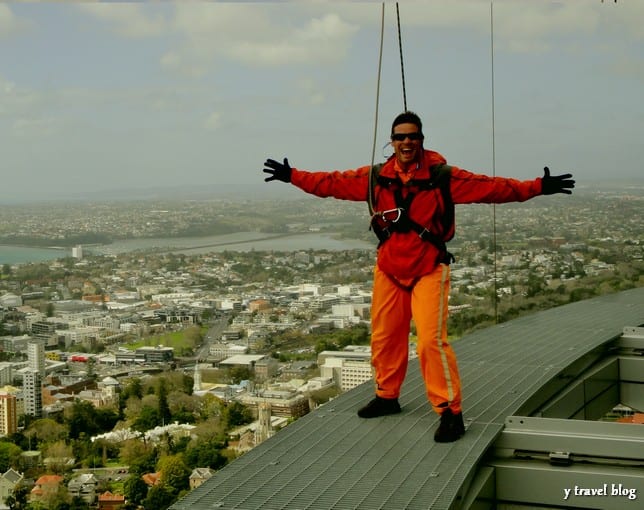craig standing arms outstretched on tower ledge