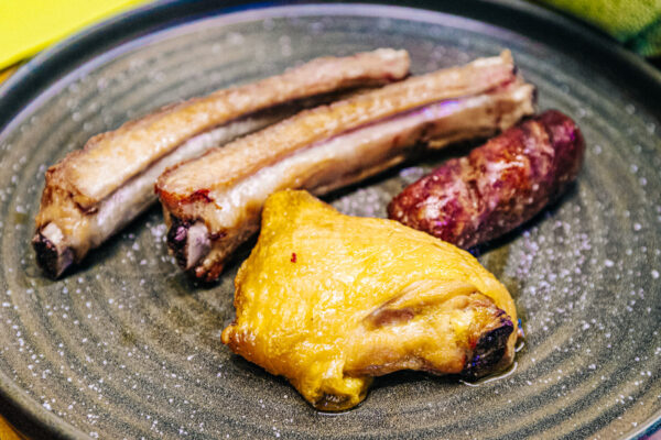 plate of tuscan meats chicken sausage and ribs